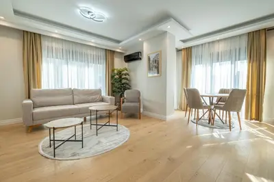 a living room with a couch and a table and chairs at Mayer Skycon Residence Besiktas in Istanbul
