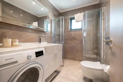 a bathroom with a washing machine and a shower at Mayer Skycon Residence Besiktas in Istanbul