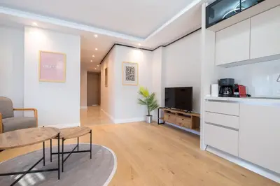 a living room with a table and a kitchen at Mayer Skycon Residence Besiktas in Istanbul