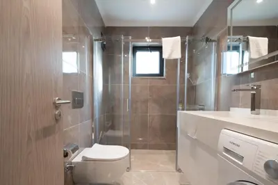 a bathroom with a toilet and a shower and a sink at Mayer Skycon Residence Besiktas in Istanbul