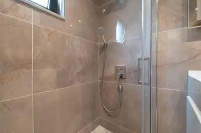 a bathroom with a shower with a glass door at Mayer Skycon Residence Besiktas in Istanbul