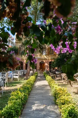 a path in front of a building with purple flowers at Anthea Butik Otel in Adalar