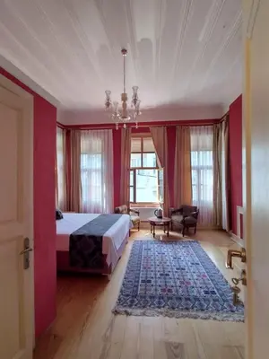 a large bedroom with a bed and a rug at Anthea Butik Otel in Adalar
