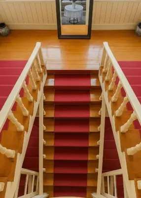 a staircase in a house with a red carpet at Anthea Butik Otel in Adalar