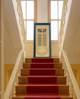 a stairway with red stairs with a vending machine at Anthea Butik Otel in Adalar