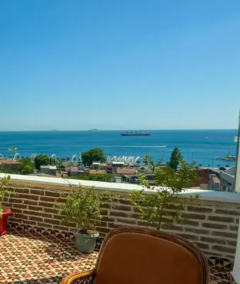 a balcony with two chairs and a view of the ocean at İstanbul Eagle's Nest Boutique Hotel in Istanbul