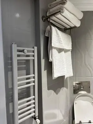 a bathroom with a towel rack next to a toilet at New Hotel Harbiye in Istanbul