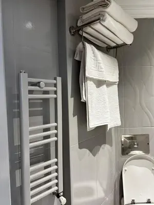 a bathroom with a towel rack next to a toilet at New Hotel Harbiye Studio in Istanbul