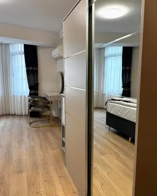 a room with a closet and a bedroom with a bed at New Hotel Harbiye Studio in Istanbul