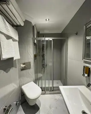 a bathroom with a shower and a toilet and a sink at New Hotel Harbiye Studio in Istanbul