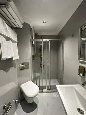 a bathroom with a shower and a toilet and a sink at New Hotel Harbiye Studio in Istanbul