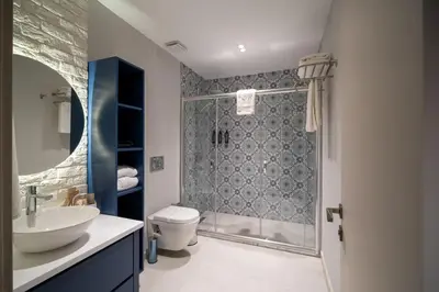 a bathroom with a shower and a toilet and a sink at Querencia Hotel in Istanbul