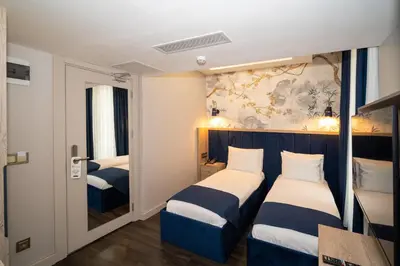 a hotel room with two beds and a window at Querencia Hotel in Istanbul