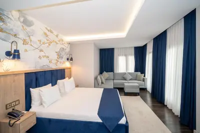 a hotel room with a bed and a couch at Querencia Hotel in Istanbul