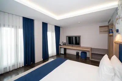 a hotel room with a bed and a television at Querencia Hotel in Istanbul
