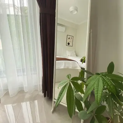 a mirror in a room with a bed and a plant at High Garden Villas in Sapanca