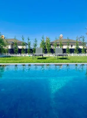 two chairs sitting next to a pool of water at High Garden Villas in Sapanca