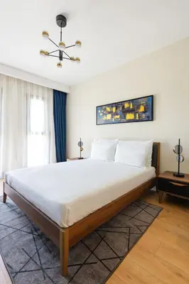 a bedroom with a large bed with white sheets at The Superior Living Kağıthane in Istanbul