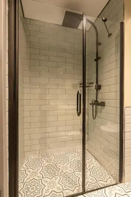 a shower with a glass door in a bathroom at The Superior Living Kağıthane in Istanbul