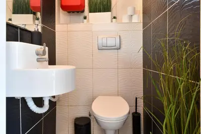 a bathroom with a white toilet and a sink at Taksim-Galata Tower Is Almost In Your Bedroom And In The Balconies Rooftop Terrace with Golden Horn View in Istanbul