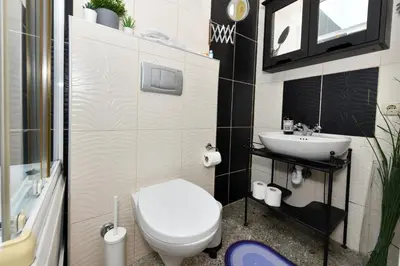 a bathroom with a white toilet and a sink at Taksim-Galata Tower Is Almost In Your Bedroom And In The Balconies Rooftop Terrace with Golden Horn View in Istanbul