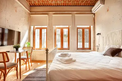 a bedroom with a bed and a table and chairs at Armel Homes Beyoğlu in Istanbul