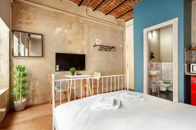 a bedroom with a bed and a table with chairs at Armel Homes Beyoğlu in Istanbul