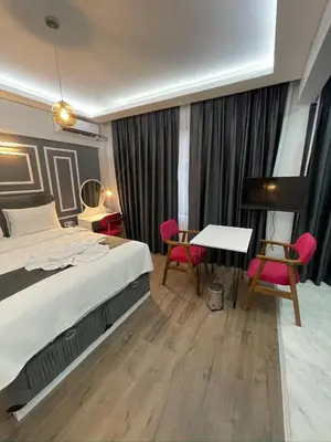 a bedroom with a bed and a desk and a piano at Fabesco Suite in Istanbul