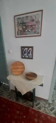 a table with two wooden seats on top of it at Town center house in İznik
