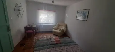 a living room with a chair and a window at Town center house in İznik