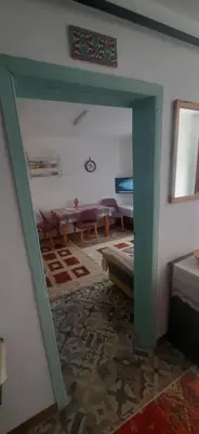 a living room with a green doorway and a table at Town center house in İznik