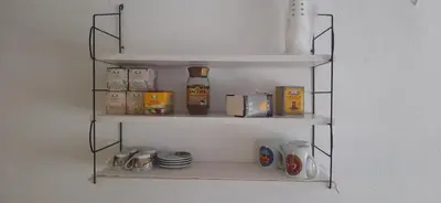 a shelf with food and other items on it at Town center house in İznik