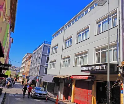 a city street with buildings and people walking down the street at Nagehan Hotel Old City in Istanbul