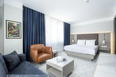 a hotel room with a bed and a couch at Noble Pangaltı in Istanbul