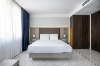 a bedroom with a large bed with white sheets at Noble Pangaltı in Istanbul