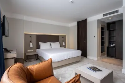 a hotel room with a bed and a couch at Noble Pangaltı in Istanbul
