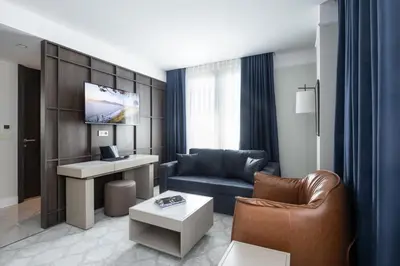 a living room with a couch and a desk at Noble Pangaltı in Istanbul
