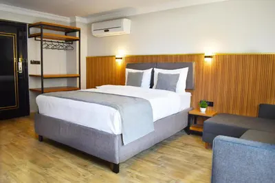 a bedroom with a large bed and a couch at Vera Taksim Hotel in Istanbul