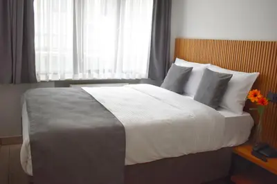 a bedroom with a large bed with white sheets and pillows at Vera Taksim Hotel in Istanbul
