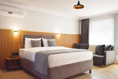 a bedroom with a large bed and a chair at Vera Taksim Hotel in Istanbul