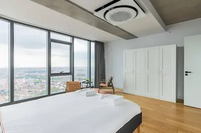 a bedroom with a large bed and large windows at Gorgeous 3BD2Bath Bright Airy Penthouse! #355 in Istanbul