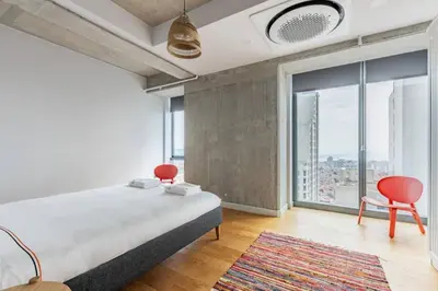 a bedroom with a bed and two chairs and a large window at Gorgeous 3BD2Bath Bright Airy Penthouse! #355 in Istanbul