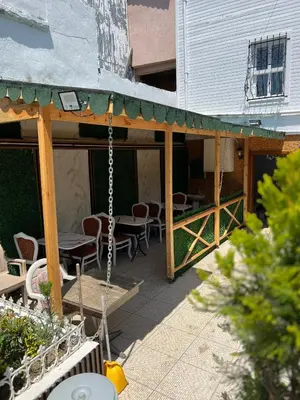 a patio with a swing and tables and chairs at Mihri Hatun Suite in Istanbul