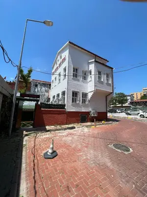 a white building sitting on top of a brick street at Mihri Hatun Suite in Istanbul