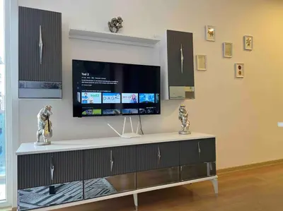 a entertainment center with a flat screen tv on a wall at Cozy Homes - 2 Rooms & 1 Living room Apartment in Esenyurt