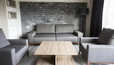 a living room with a couch and two chairs and a table at Sun Suites in Istanbul