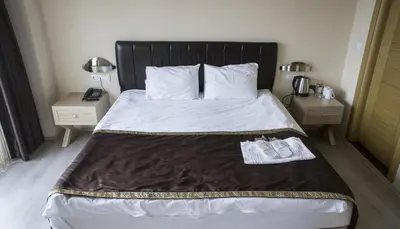 a bedroom with a bed with a pair of shoes on it at Sun Suites in Istanbul