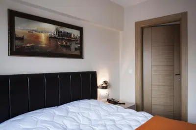 a bedroom with a bed and a picture on the wall at Sun Suites in Istanbul