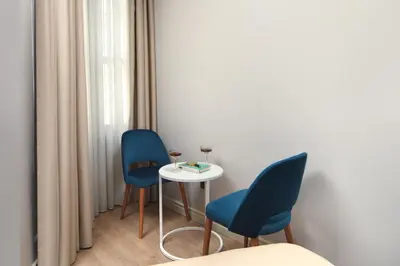 a room with two blue chairs and a small table at Ess Hotel in Istanbul
