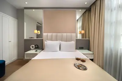 a bedroom with a large bed with two glasses on it at Ess Hotel in Istanbul